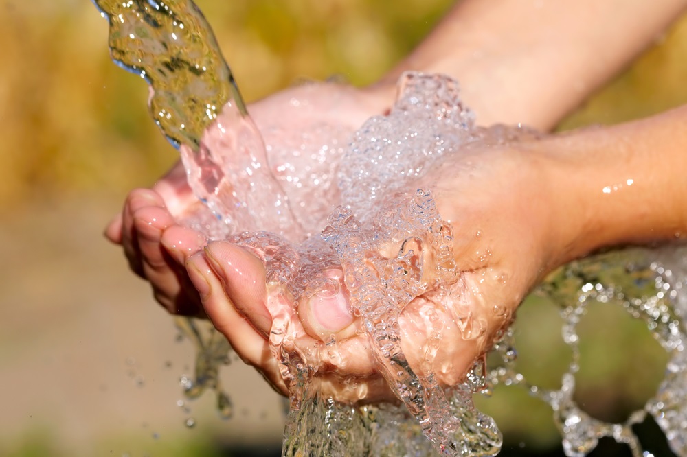 Woman’s hands with water splash